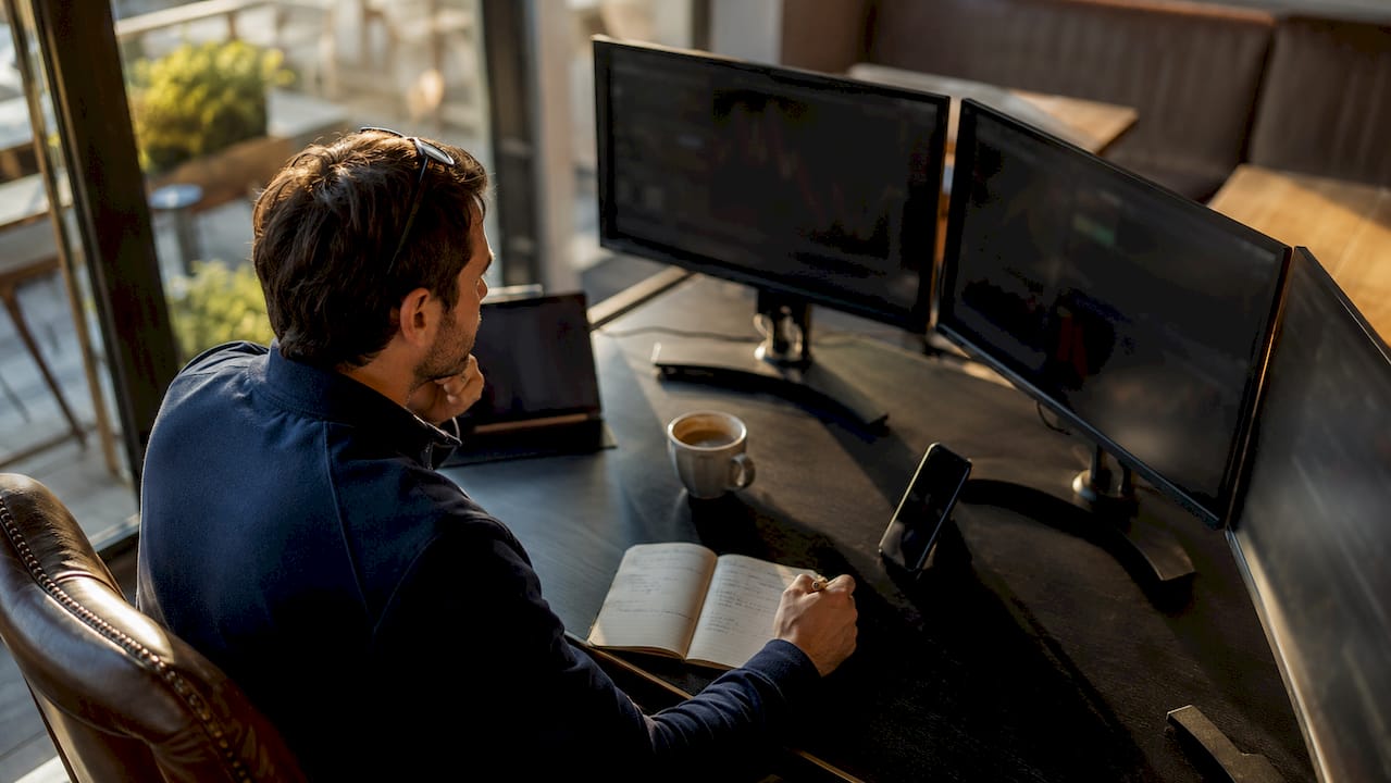 Trader at desk analyzing live trade data