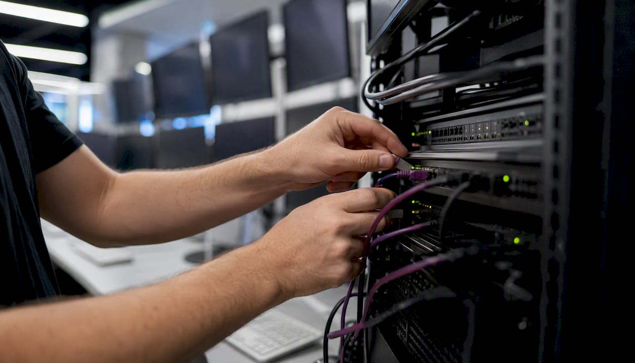 Hands connecting local trade server cables