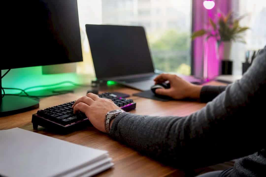 Hands configuring software settings on trading desk