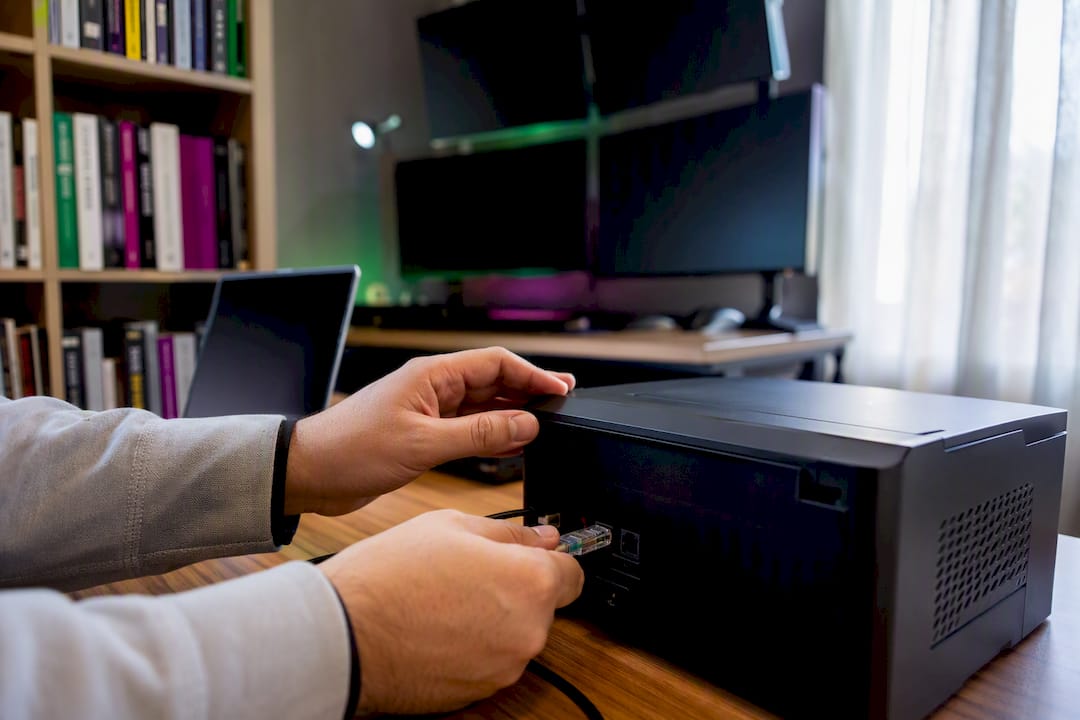 Hands connecting network cable in trading VPS room