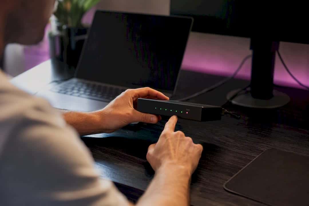 Hands adjusting control knobs on device