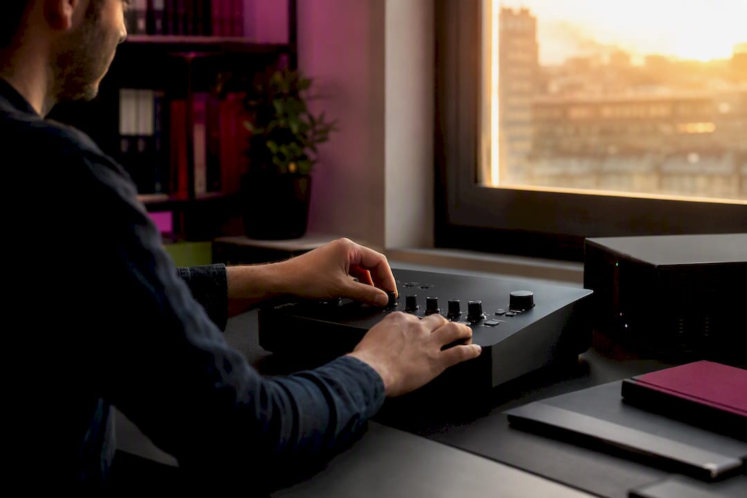 Hands adjusting lot size controls on trading device