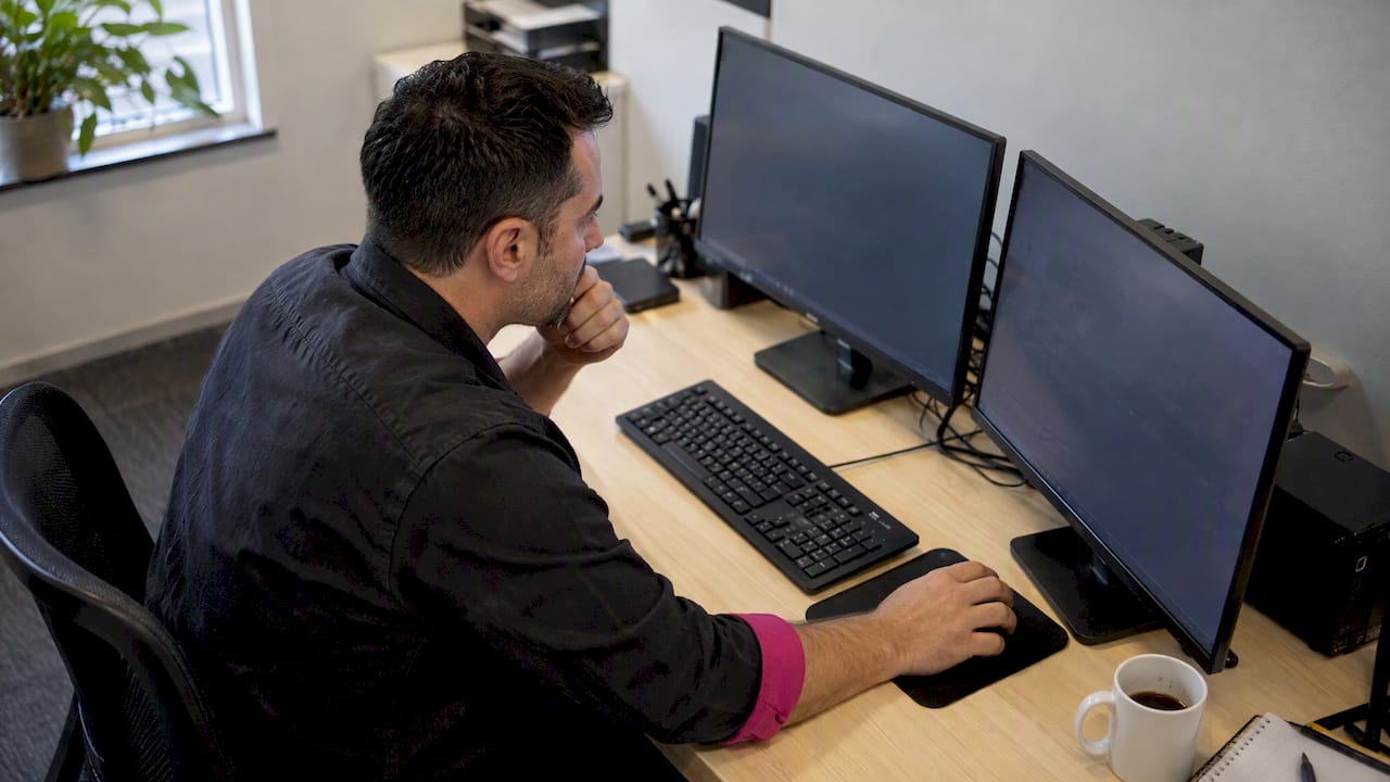 Trader checking synchronized forex order terminals